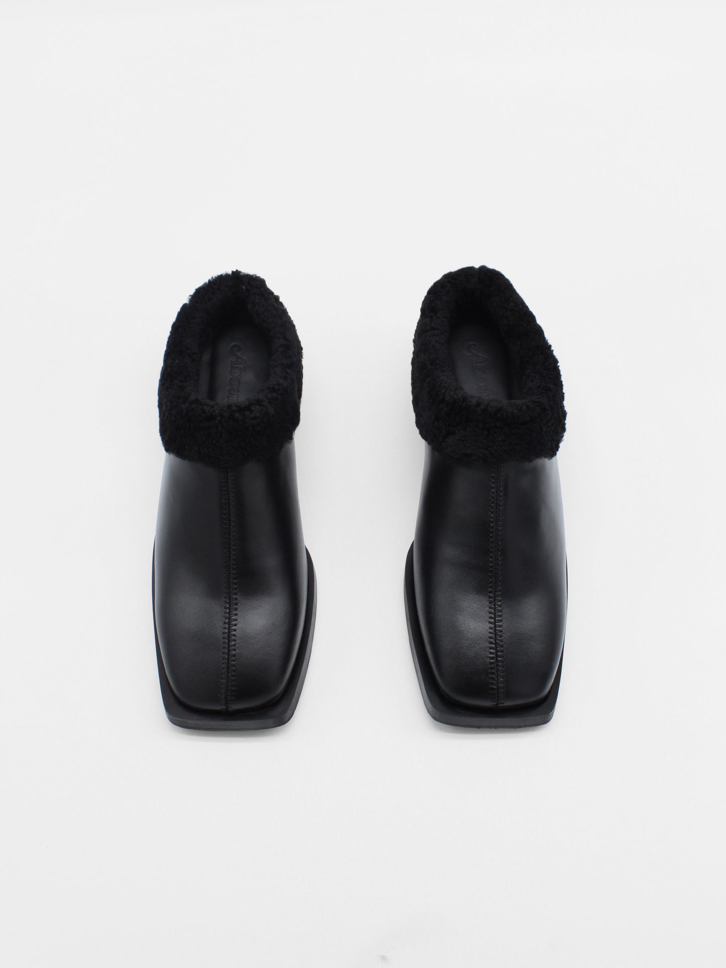 About Arianne flat black leather mules