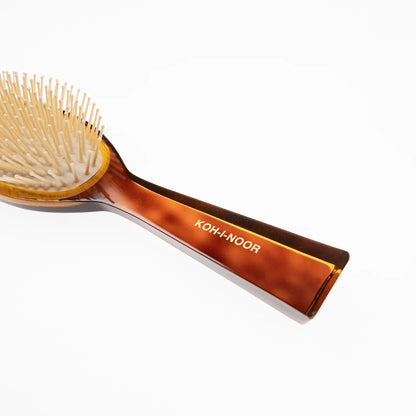 Hair brush with plastic bristles