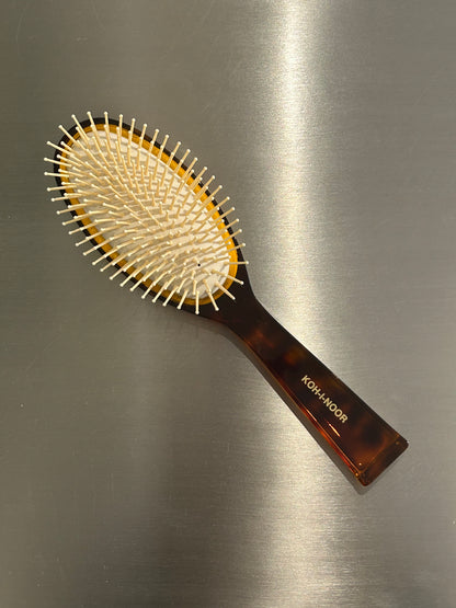 Hair brush with plastic bristles