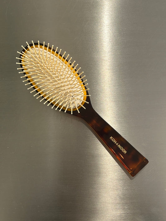 Hair brush with plastic bristles